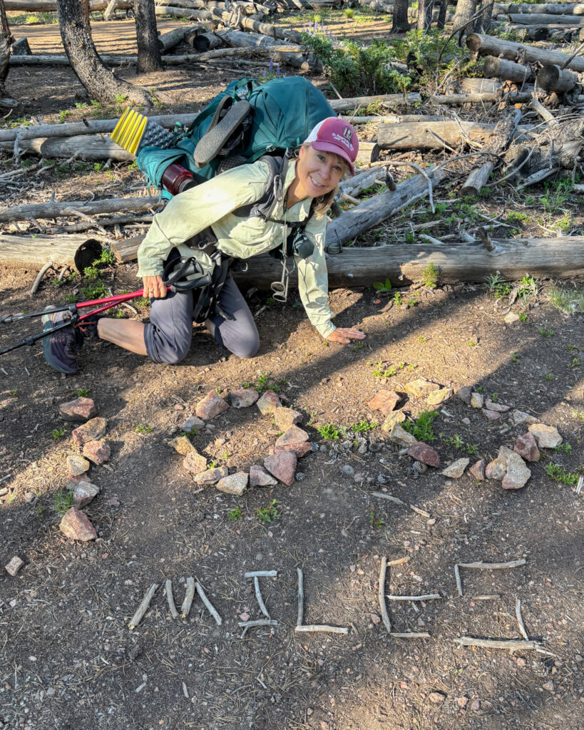 Melissa on the Colorado Trail at the 100 Mile sign